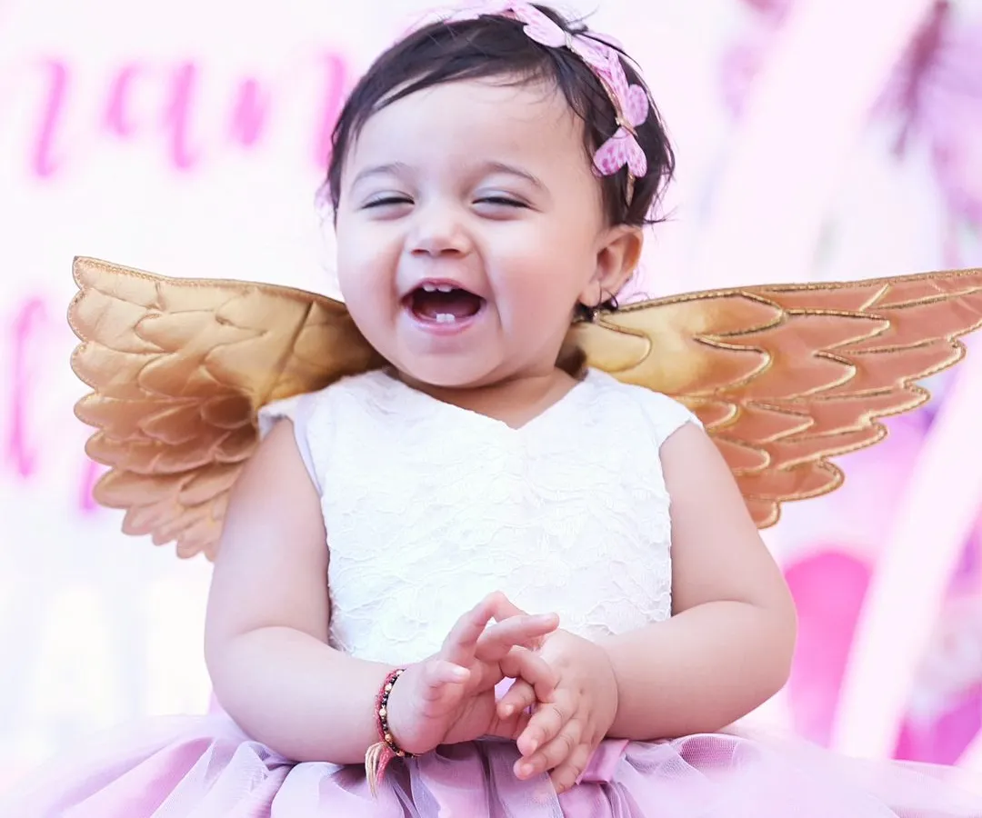 Look at that pure, unfiltered joy! We believe the best photos happen when kids are just being themselves. This is from a first birthday party, and this little angel's laugh made our day.