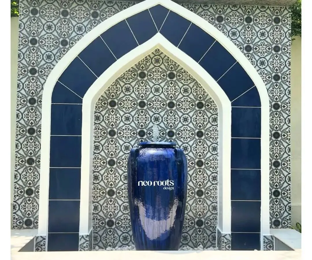 This Moroccan-inspired water feature serves as a stunning focal point. We used intricate patterned tiles and a bold blue ceramic urn to create a piece that is both a work of art and a source of tranquil sound, bringing a sense of timeless elegance to the garden.