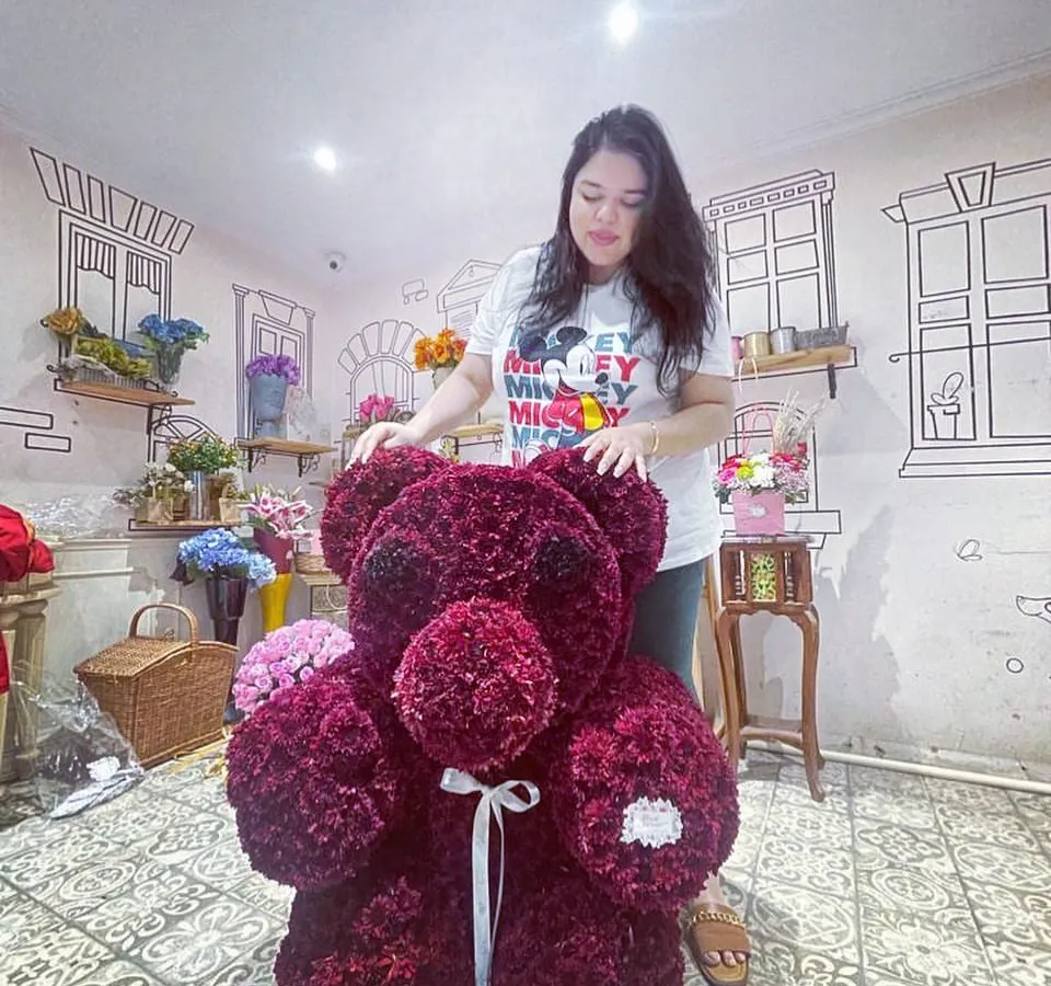 For a touch of playful romance, I created this three-foot-tall floral teddy bear using over 5,000 individual red daisy florets. It’s a unique and huggable masterpiece, perfect for when you want your gift to be both grand and full of personality.