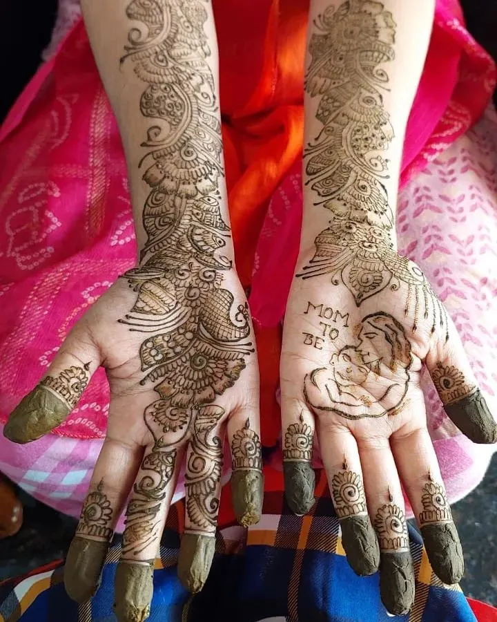 A special design for a mom-to-be, featuring a portrait of a mother and child. I love creating personalized mehendi like this for baby showers to make the day even more memorable.