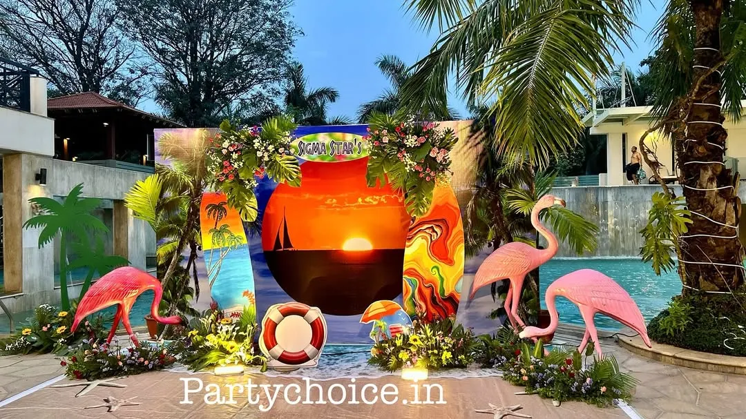 For this corporate poolside party, we created a complete beach-themed environment. The setup features a custom sunset backdrop, surfboard props, flamingo figures, and tropical foliage to create an immersive and fun atmosphere for guests.