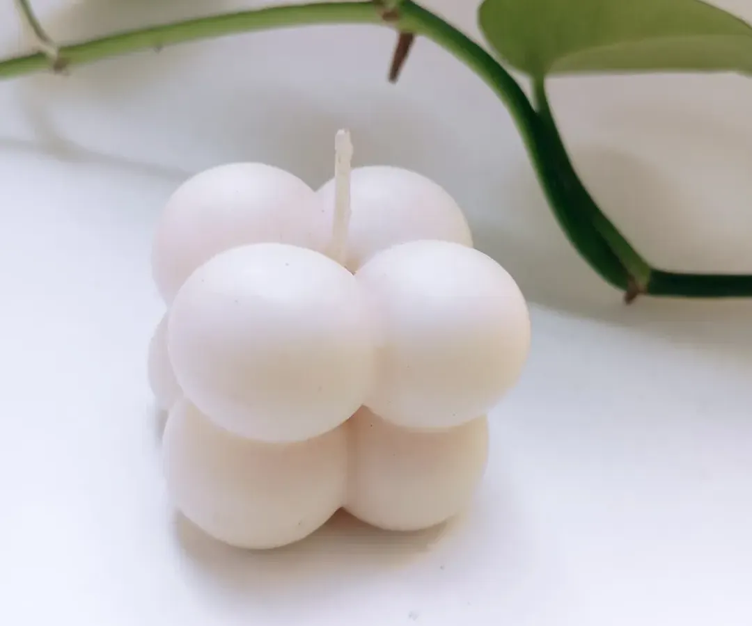 My soy wax bubble candle is a piece of decor in itself. This clean, minimalist shot shows its unique shape that brings a modern and playful touch to any space, even before it's lit.