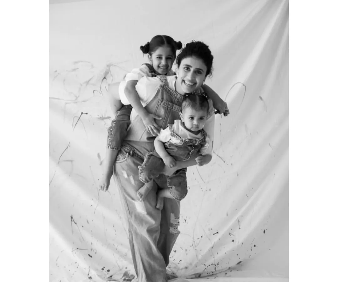 The beautiful chaos of motherhood, captured during a playful 'Paint Me' session. I love freezing these moments of pure joy, where laughter is the only thing that matters.