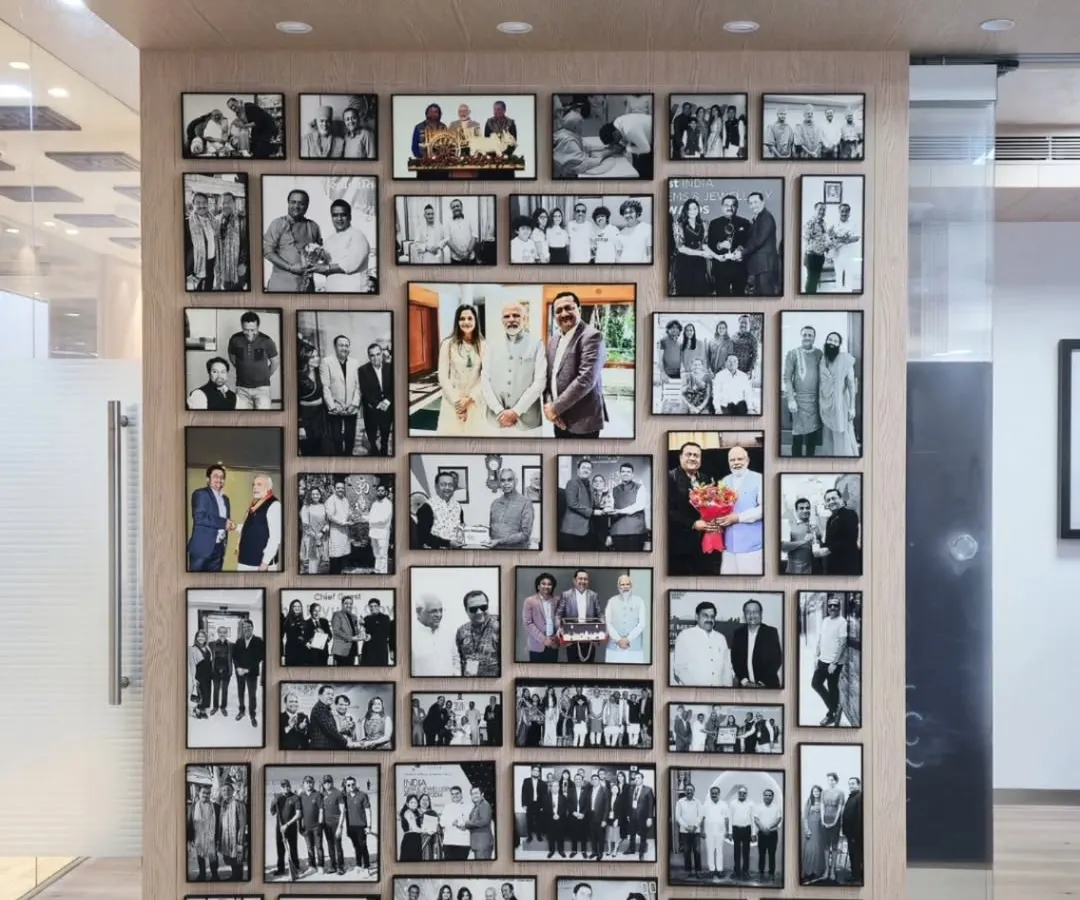 For Kiran Gems, a global leader in the diamond industry, we were entrusted to create a legacy wall from 45 of their most treasured photographs. We crafted a stunning visual timeline using premium metal frames, turning milestone moments with national leaders and historic achievements into a powerful corporate art installation.