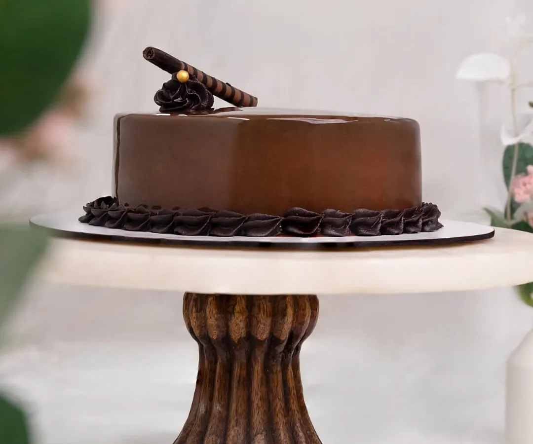 This is my classic Chocolate Truffle Cake, a favorite for any celebration. I use only pure couverture chocolate for that deep, rich flavor, layered with a moist sponge and a glossy ganache finish. It’s elegance you can taste.