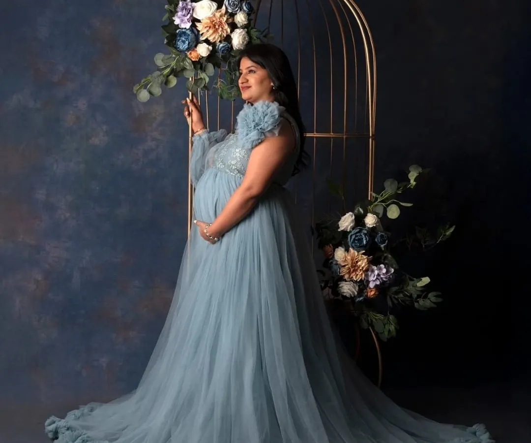 For the mama who wants to feel like a queen. In my studio, we create these elegant, glamorous portraits with flowing gowns and artistic setups like this floral cage, celebrating your strength and beauty in this powerful chapter.