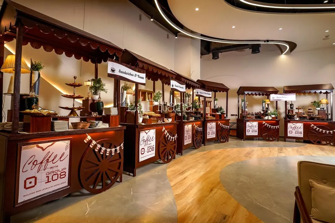 We transformed a corporate space into a bustling "Coffee Fest" with a series of custom-designed stalls. This wide shot shows the scale of the event, creating a market-like atmosphere that encourages guests to explore, connect, and enjoy the experience we built.