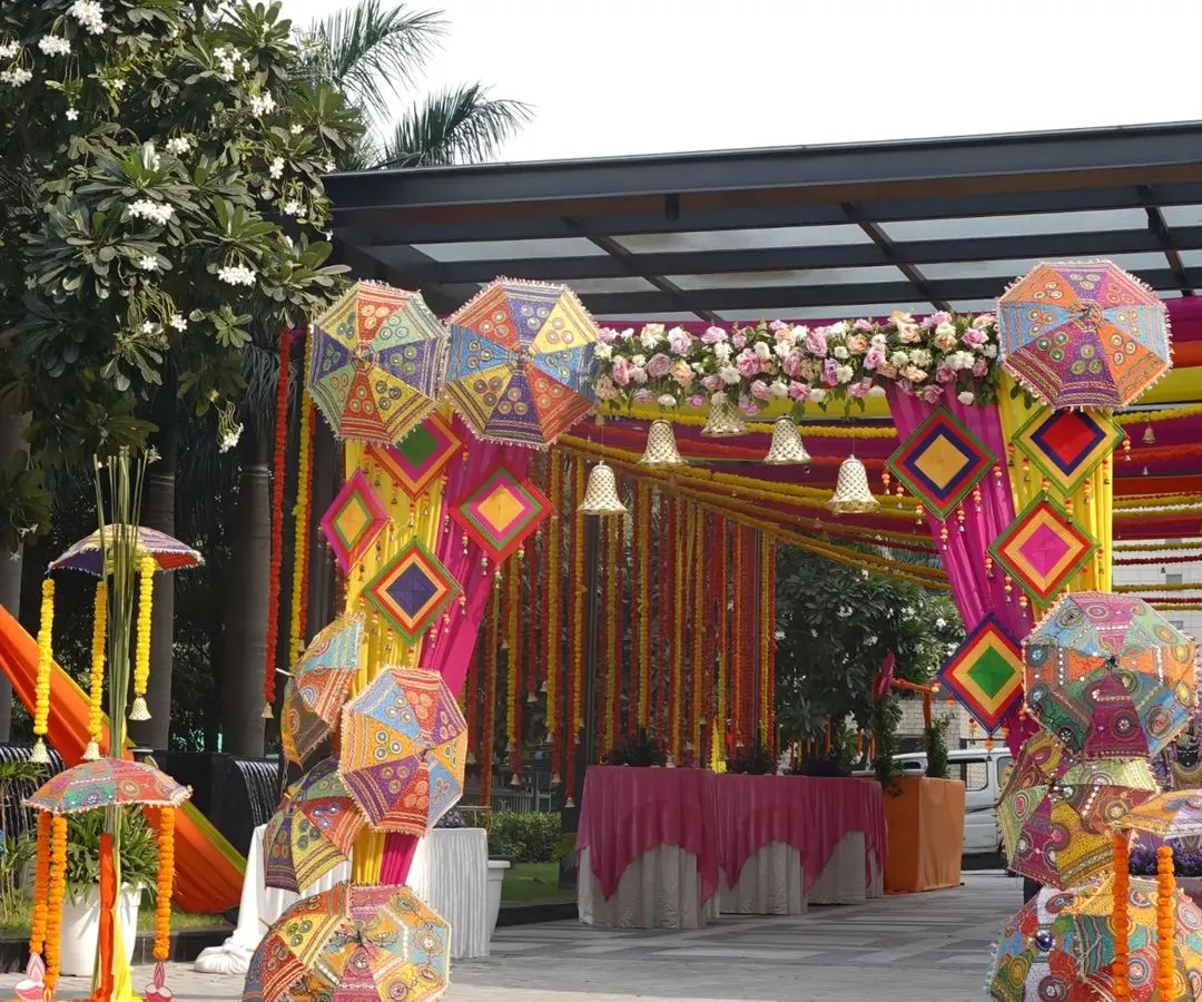 Welcome your guests with a burst of color and tradition. For this Mehendi, I created a vibrant entrance using Rajasthani patchwork umbrellas and marigold garlands, setting a joyful and festive tone from the very first step.