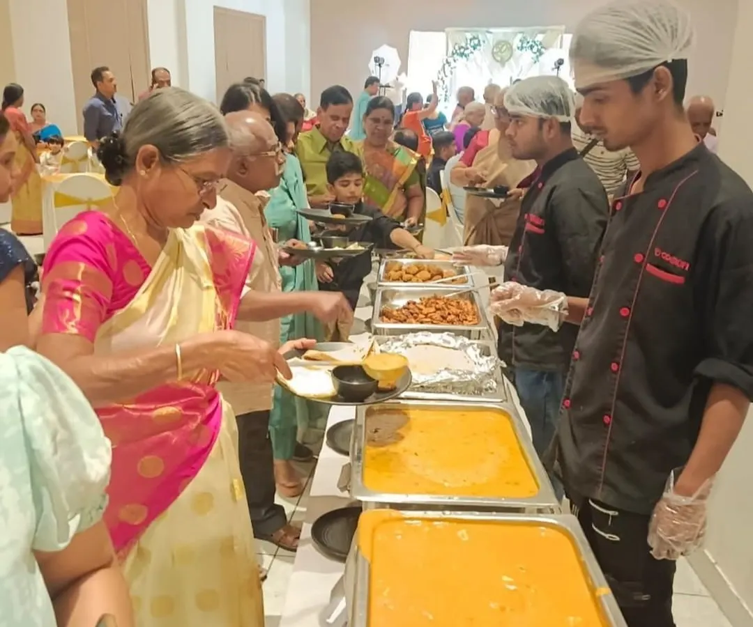 We believe in attentive service for all your guests. Here, one of our staff members assists a guest at a wedding anniversary celebration, ensuring everyone feels welcomed and cared for.