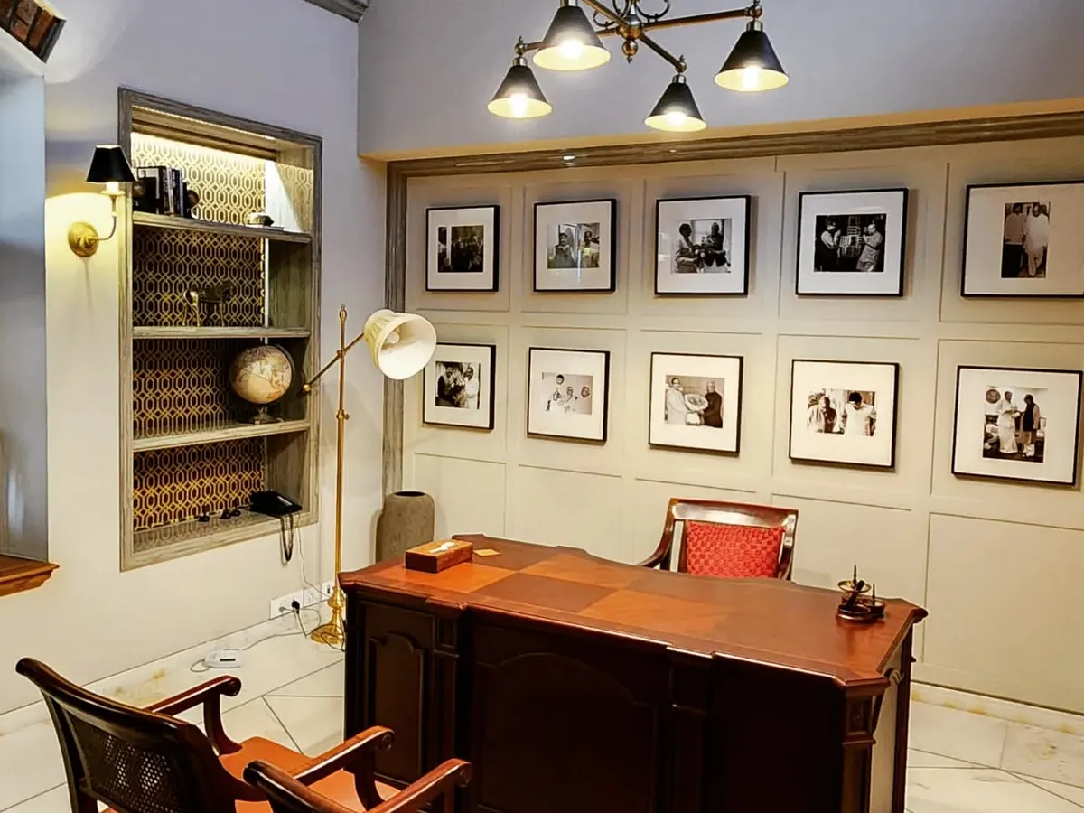 This home office, designed for a renovated bungalow in the Lutyens Delhi area, is a study in functional elegance. We created a gallery wall to celebrate the client's personal journey, paired with classic wooden furniture and carefully selected lighting to build a sophisticated and inspiring work ambiance.