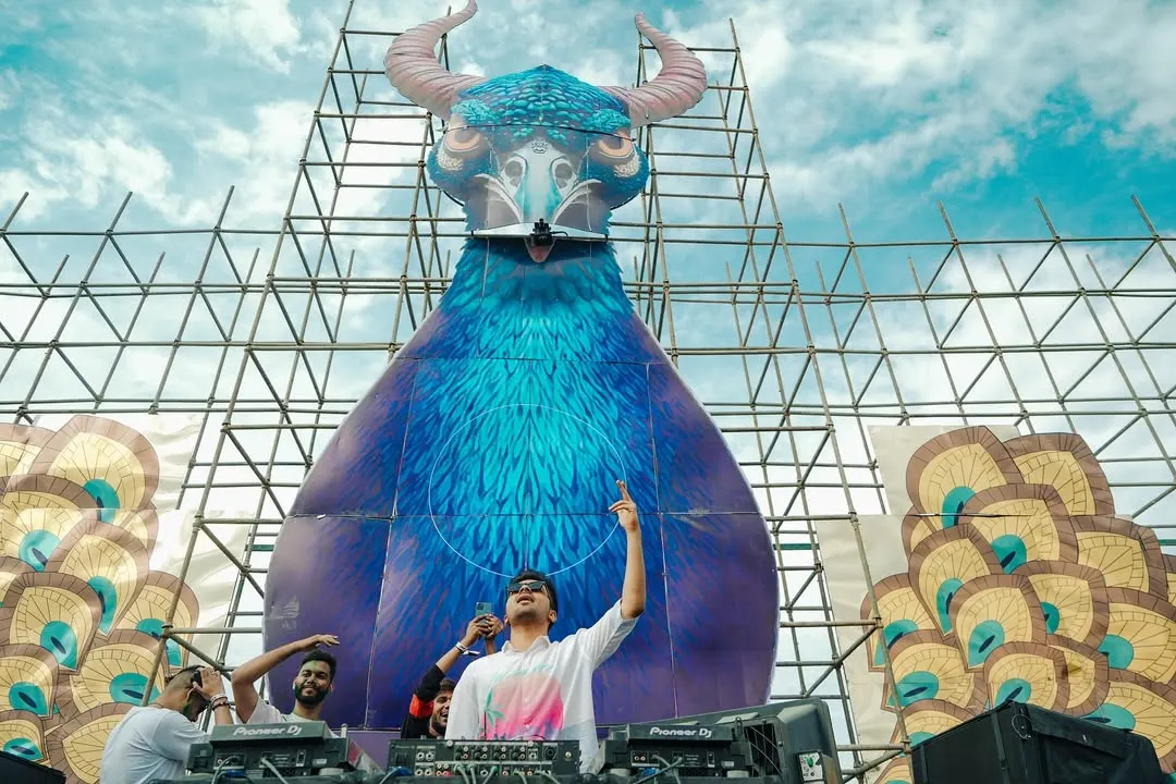 Playing at a massive Holi festival is a different kind of energy. This shot, with the incredible stage art and a sea of people, captures the scale and vibrant atmosphere I bring to large scale events and music festivals.