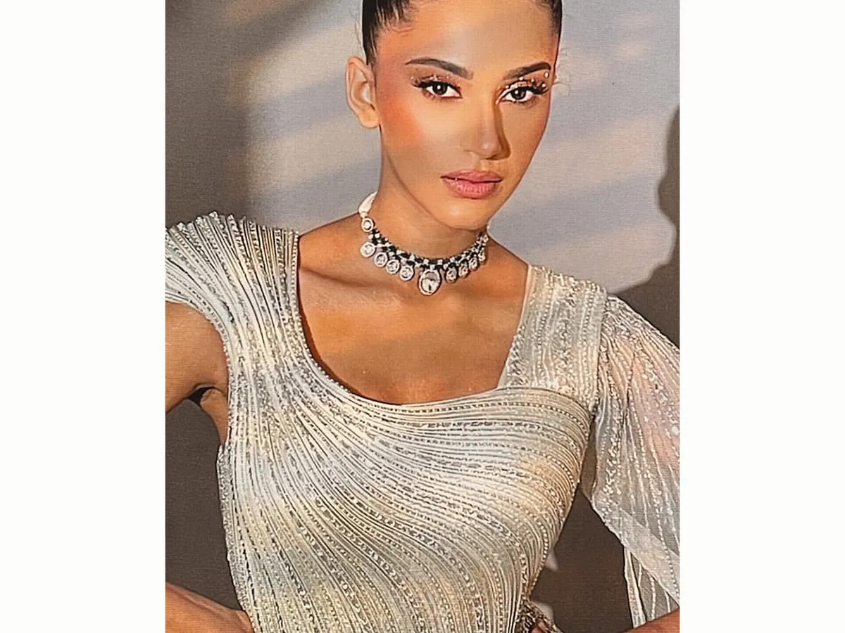 For a glamorous reception or engagement, I styled this shimmering, silver-toned gown. The sleek high bun and minimalist polki necklace complete a modern bridal look that is both elegant and party-ready.