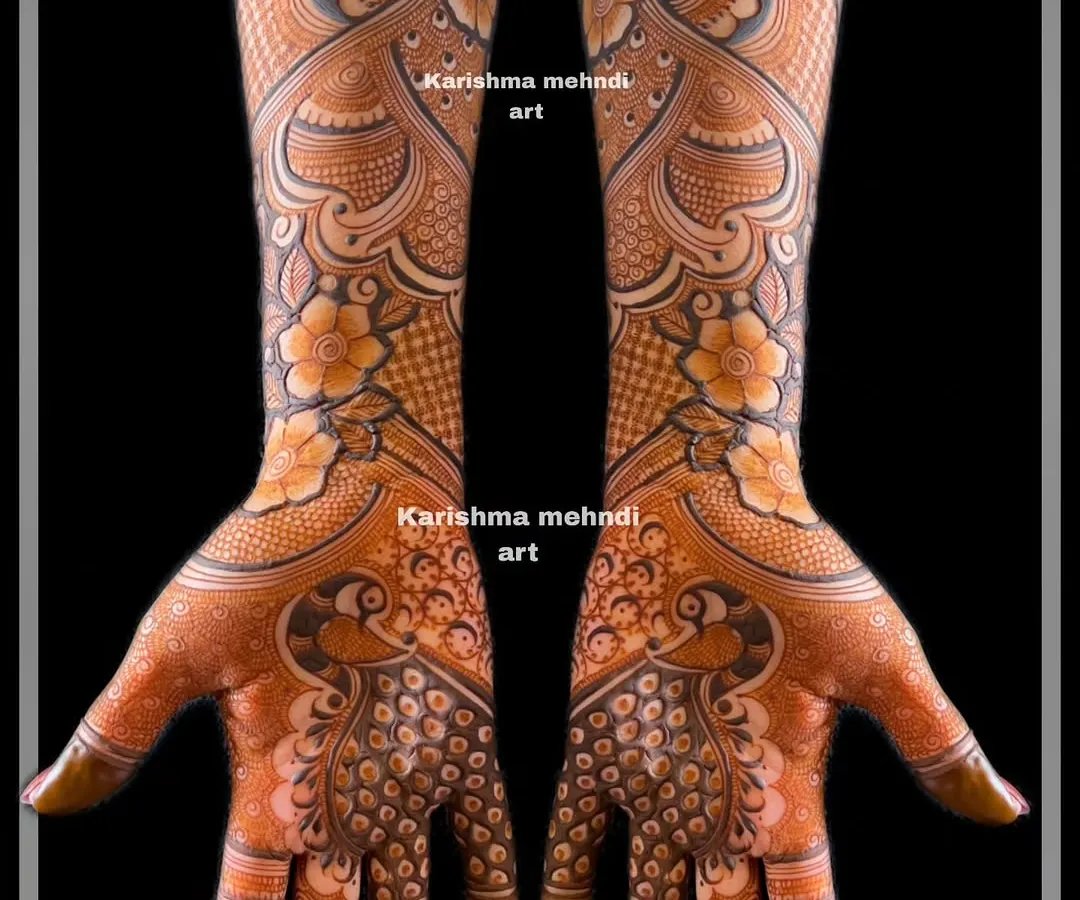 This is a perfect example of intricate mehendi for guests, often called 'siders work'. This design features symmetrical peacocks and detailed patterns, offering a rich, full-hand look for bridesmaids and close family.