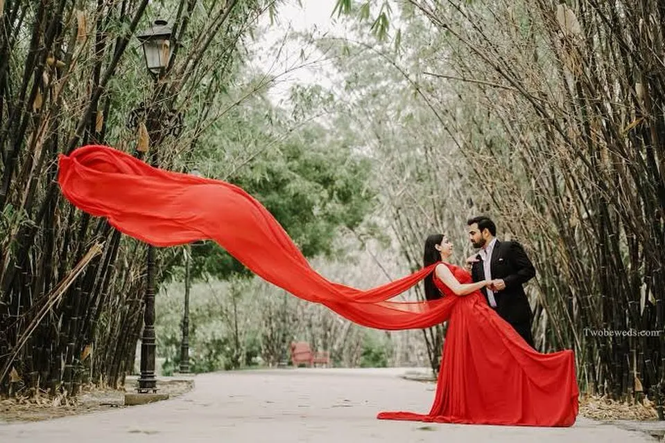 Create your own movie moment with our pre-wedding photoshoot gowns. This dramatic red gown with a long, flowing trail is designed to make a statement and give you breathtaking photos you'll cherish forever.