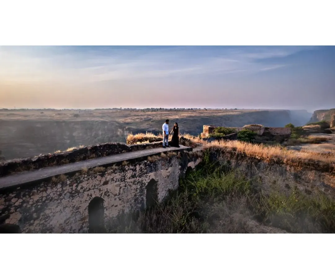 A couple shares a quiet moment on an old stone bridge during their pre-wedding shoot. Using the drone allows me to capture both the intimacy and the epic scale of the landscape.