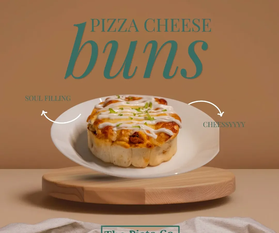 Introducing our Pizza Cheese Buns, the perfect savory snack. This image shows a single, fluffy bun on a clean white plate, topped with melted cheese and a sprinkle of herbs, promising a soul-filling and cheesy bite every time.