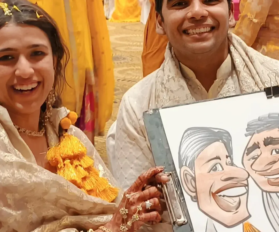 Nothing makes a wedding celebration more memorable than unique entertainment. Here's a happy couple at their Hyatt haldi function with a fun caricature to remember their special day. I love adding a touch of artistic fun to wedding festivities.