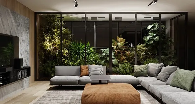 We transformed this living room by installing a floor-to-ceiling glass-enclosed garden. This lush installation acts as a living wall, providing a constant view of vibrant greenery while separating the space with style.
