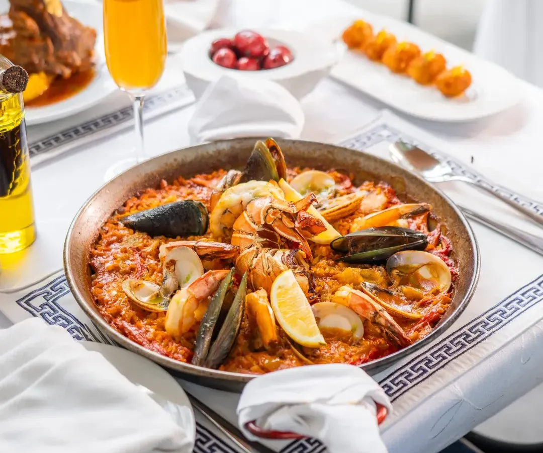 My seafood paella, a dish that tells the story of Spain. Made with saffron-infused rice and the freshest catch, it’s a centerpiece for any celebration, bringing people together around the pan.