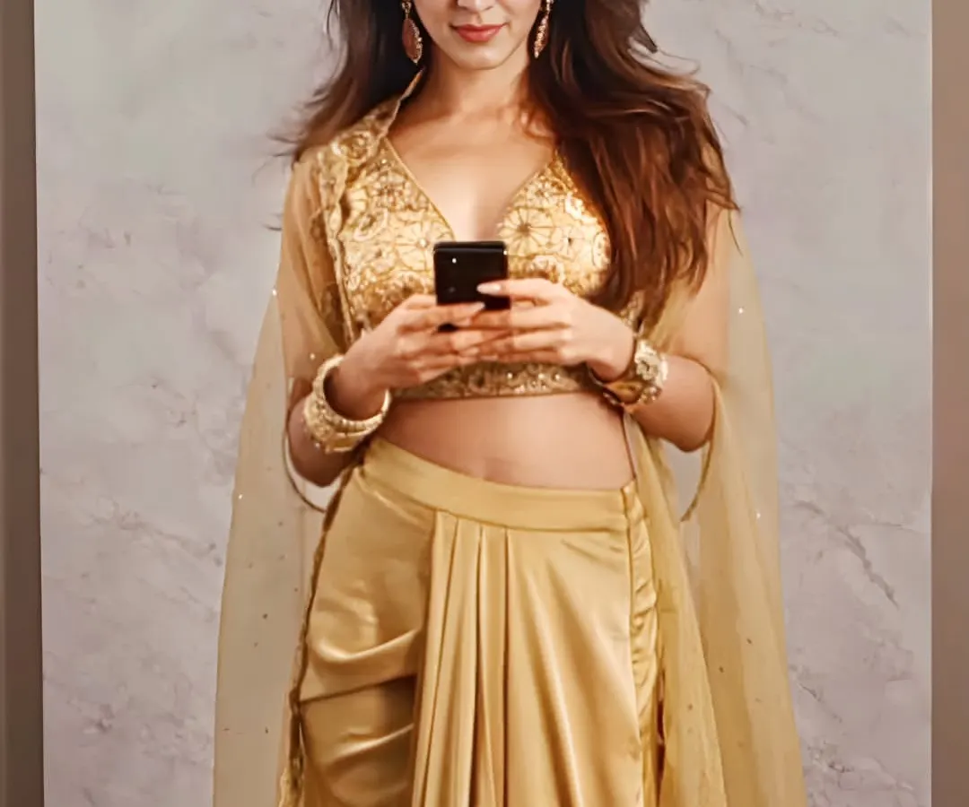 The stunning Kiara Advani in my golden Lydia Cape Set. This fusion wear piece combines a pre-draped dhoti skirt with an intricately embroidered blouse and a flowing organza cape, perfect for a modern wedding guest look.