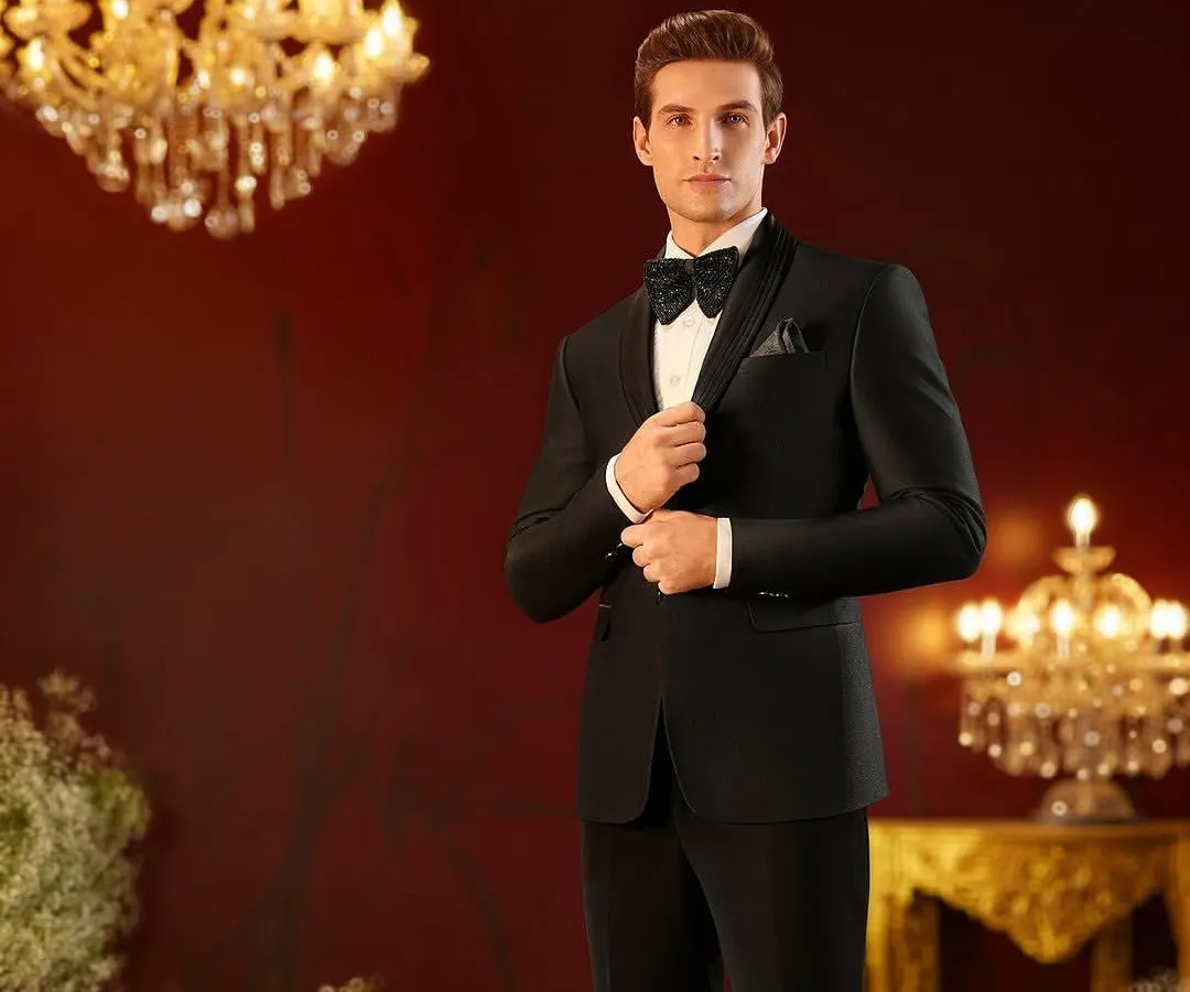 A classic black tuxedo styled for a Louis Philippe royal weddings campaign. The focus was on creating a look of timeless elegance through sharp tailoring, a peak lapel, and a perfectly knotted bow tie, set against a luxurious, warmly lit backdrop.