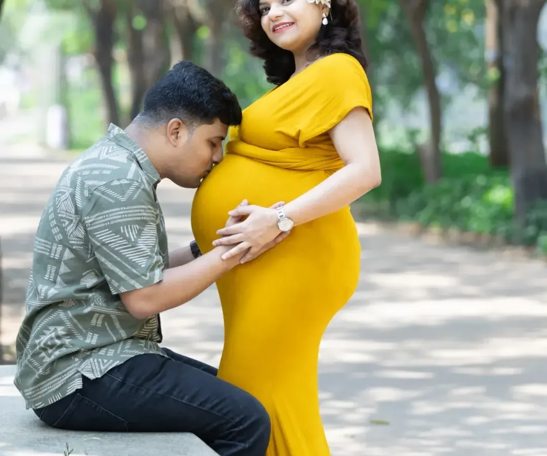 A tender moment during a maternity shoot, with an expecting father kissing his wife's belly. I love capturing this quiet connection in the soft, golden hour light of a park.
