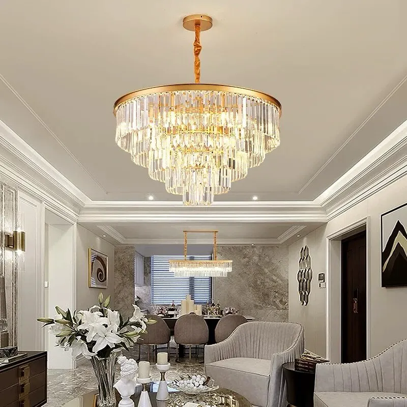 This is how we bring luxury to life. A grand, multi-tiered crystal chandelier installed in a client's living room, creating a stunning centerpiece that complements the high ceiling and elegant decor.
