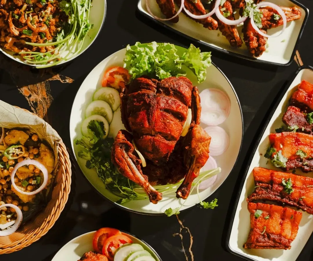 A glimpse of the variety I offer. This spread includes a whole fried chicken, crispy pork, spicy chicken preparations, and fresh salads, perfect for a family meal or a special celebration.