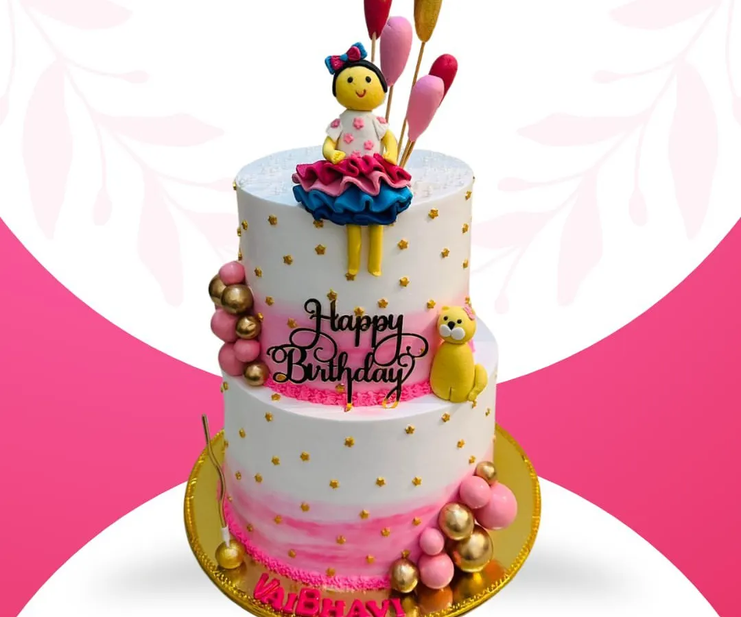 This is one of my grandest creations, a 10-pound, two-tier cake perfect for a big celebration. It features my special Rasmalai fusion flavor and is decorated with a beautiful doll topper, balloons, and personalized details for a truly memorable birthday.