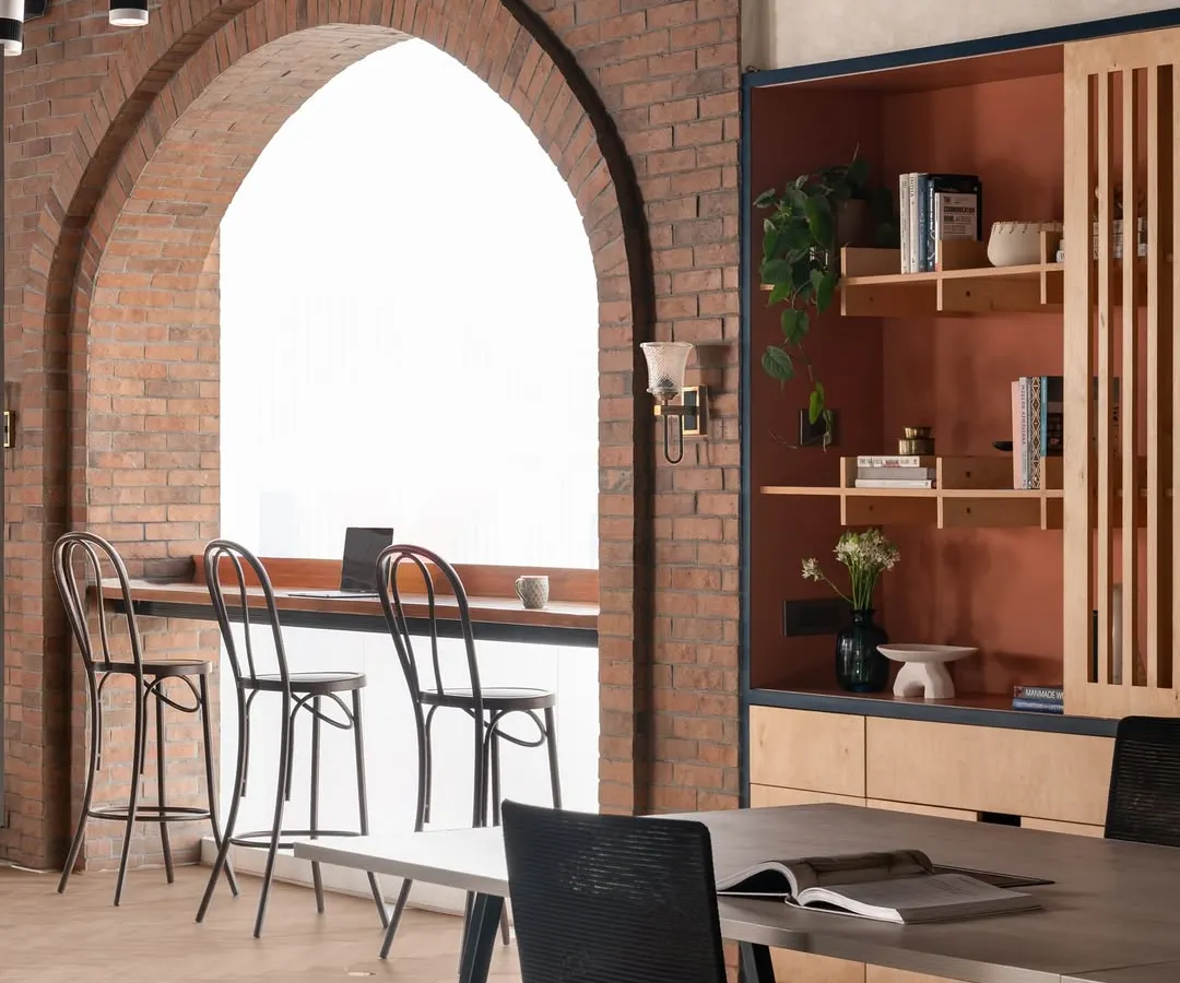 An office should inspire creativity. I designed our own studio with a statement brick arch to frame the large window, creating a bright space for brainstorming or a quiet coffee. It’s a nod to a warm, rustic style that feels both refined and welcoming.