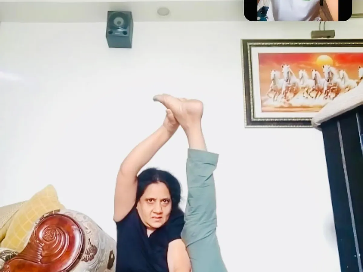 This is a glimpse into my online advanced yoga class. I give direct, real-time feedback to each student, correcting their alignment in complex poses like this seated leg-behind-head variation. It's personal training, even in a group setting.
