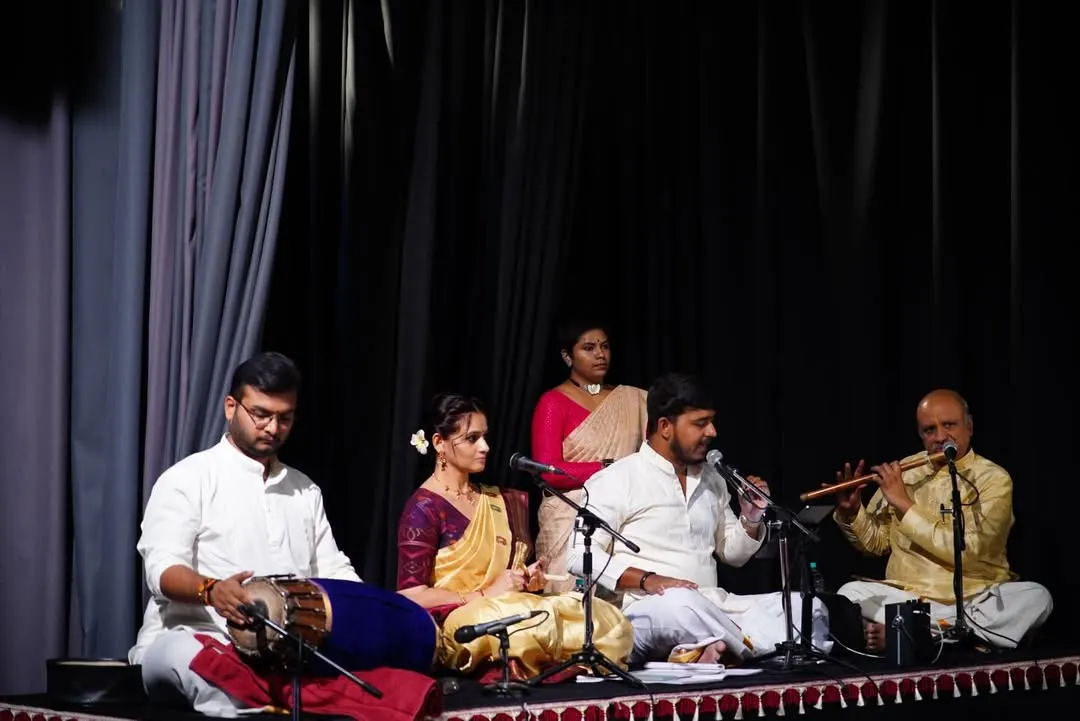 A glimpse into the soul of our performances, where music and dance become one. Here, you see our live orchestra, featuring talented vocalists, the melodic flute, and the rhythmic pulse of the mridangam, all coming together to create a truly divine experience on stage.