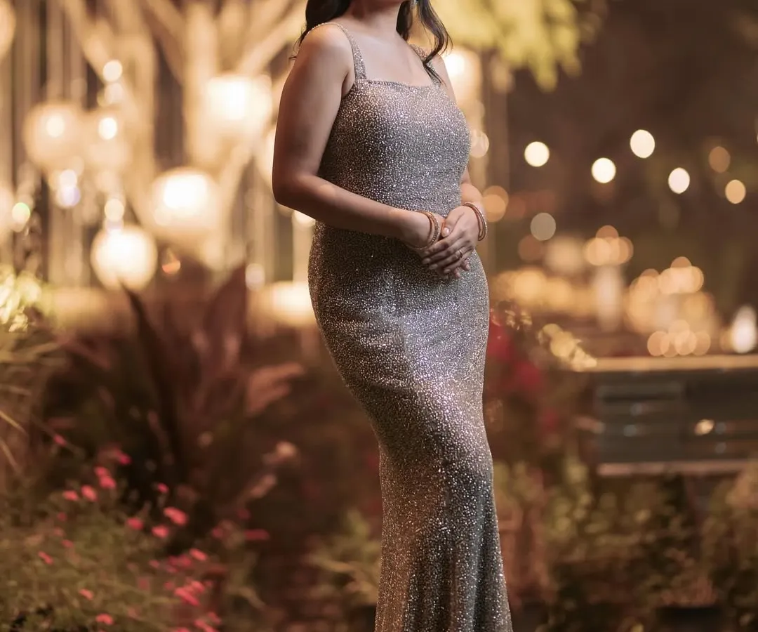 A client looking absolutely radiant in her custom-fit champagne gown. This piece is designed to shimmer and flow, making it perfect for evening galas, cocktail parties, or any special celebration where you want to shine.