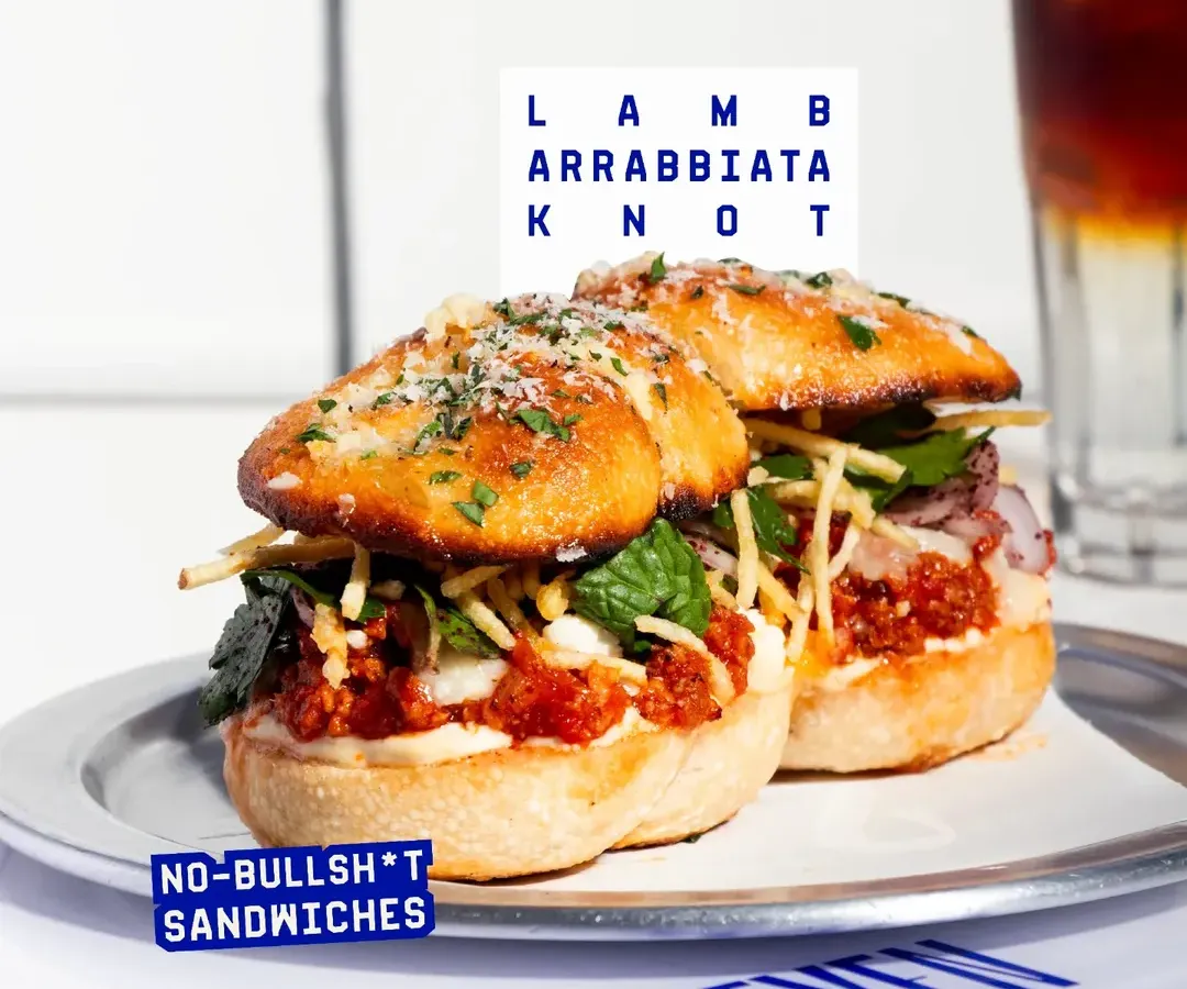 My sandwiches are anything but boring. This is the Lamb Arrabbiata Knot, packed with spicy lamb, whipped garlic yogurt, and fresh mint salad, all stuffed into our signature garlic knots. It's a full-on flavour experience.