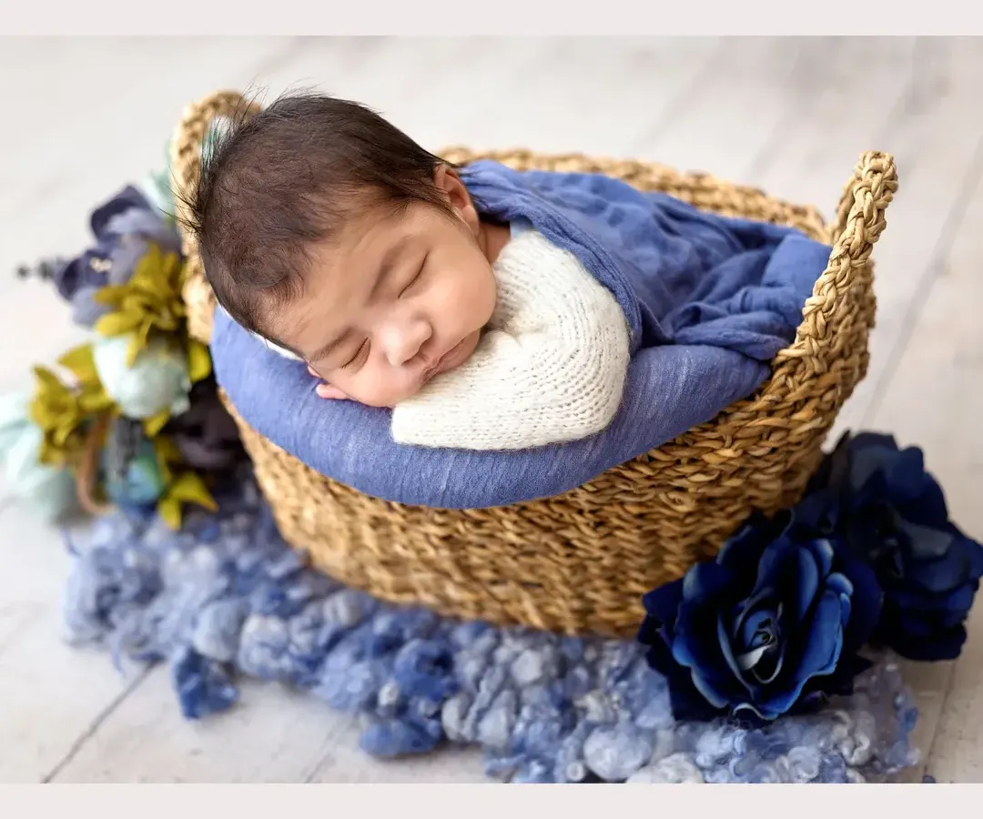 I just can't get over the sweetness of this little one. Safely posed and sleeping so peacefully in a rustic woven basket, this classic newborn portrait captures those precious, fleeting moments with a beautiful blue color palette.