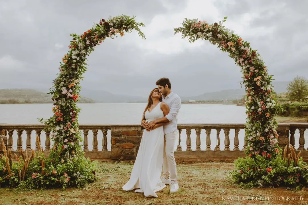 A beautiful pre-wedding portrait session by the lake, framed by a stunning floral arch. I love creating these grand, scenic shots that feel like a fairytale.