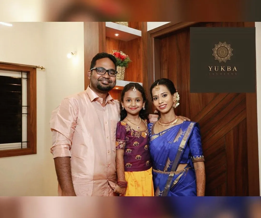 Creating coordinated outfits for the entire family is one of my greatest passions. Here, we designed a cohesive look for a family event, using complementary colors and traditional fabrics. The daughter’s custom Pattu Pavadai perfectly harmonizes with her parents' elegant ethnic wear.