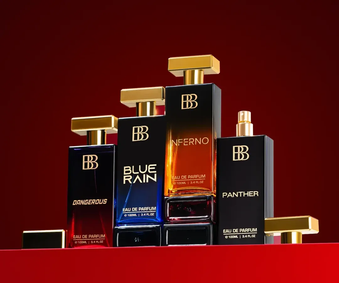 A hero shot for a luxury perfume range. We arranged the full collection to create a powerful, unified image, using a rich red background and precise lighting to make the glass bottles and gold caps stand out. This type of group shot is perfect for website banners and ad campaigns.