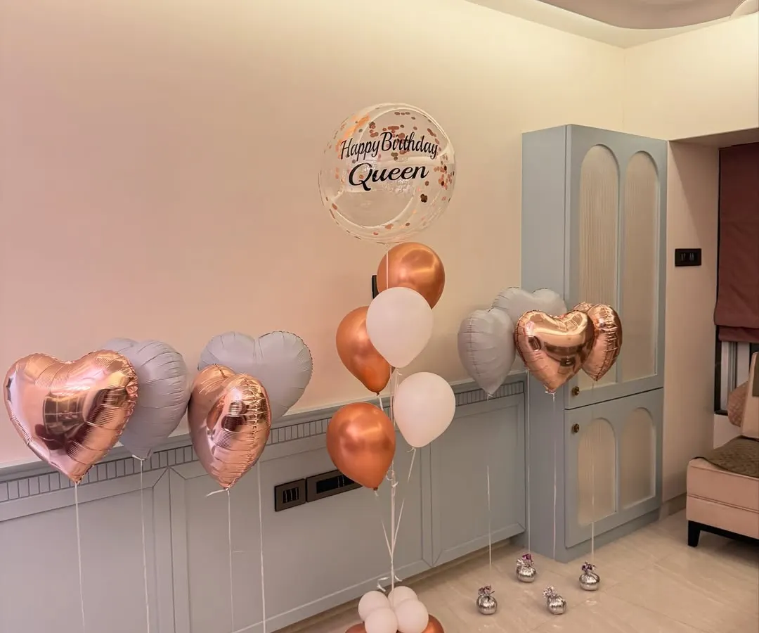 We love creating the perfect birthday aesthetic. This assorted balloon bouquet features rose gold hearts, a personalized "Happy Birthday Queen" bubble balloon, and a soft pastel color palette for a totally chic celebration.