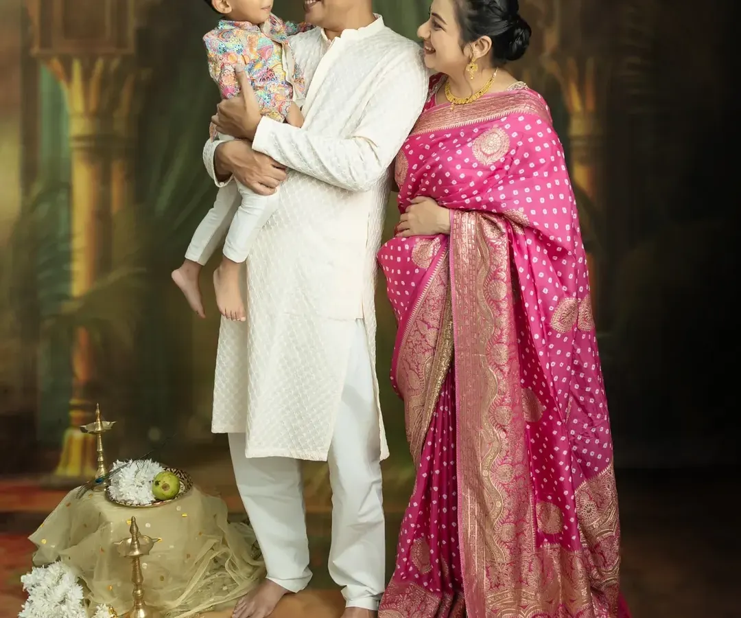 There's nothing more beautiful than capturing the whole family's excitement. This studio portrait, with everyone in coordinated traditional wear, shows the love and anticipation as you wait for your new arrival.