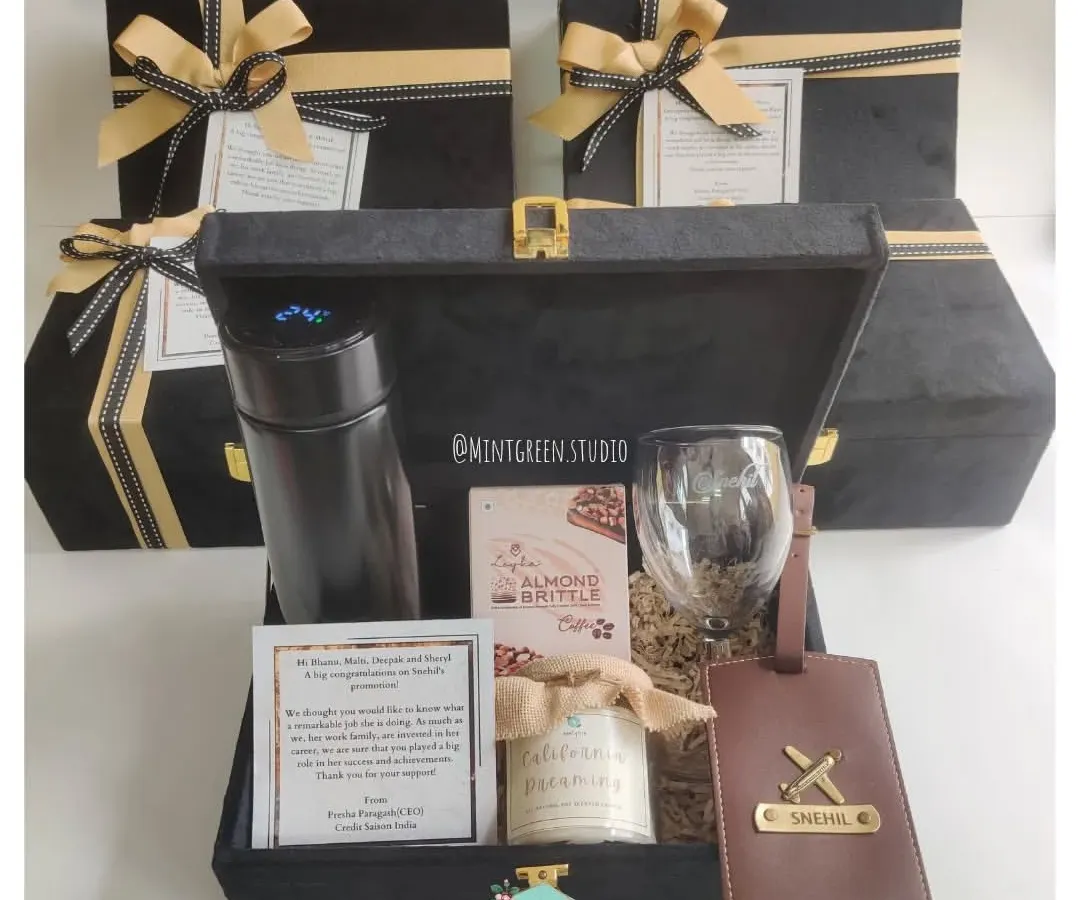 For corporate gifting that feels personal and premium, I curated these elegant black suede boxes. Each hamper includes a mix of practical and luxury items like a temperature-display flask, a personalized leather luggage tag, gourmet almond brittle, and a wine glass, all designed to make your employees and clients feel truly valued.