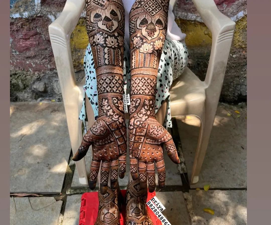 Here is a complete bridal mehndi look, with detailed, symmetrical designs covering the arms, hands, feet, and legs. I ensure the patterns flow beautifully for a stunning result from every angle, making you feel like a queen on your special day.