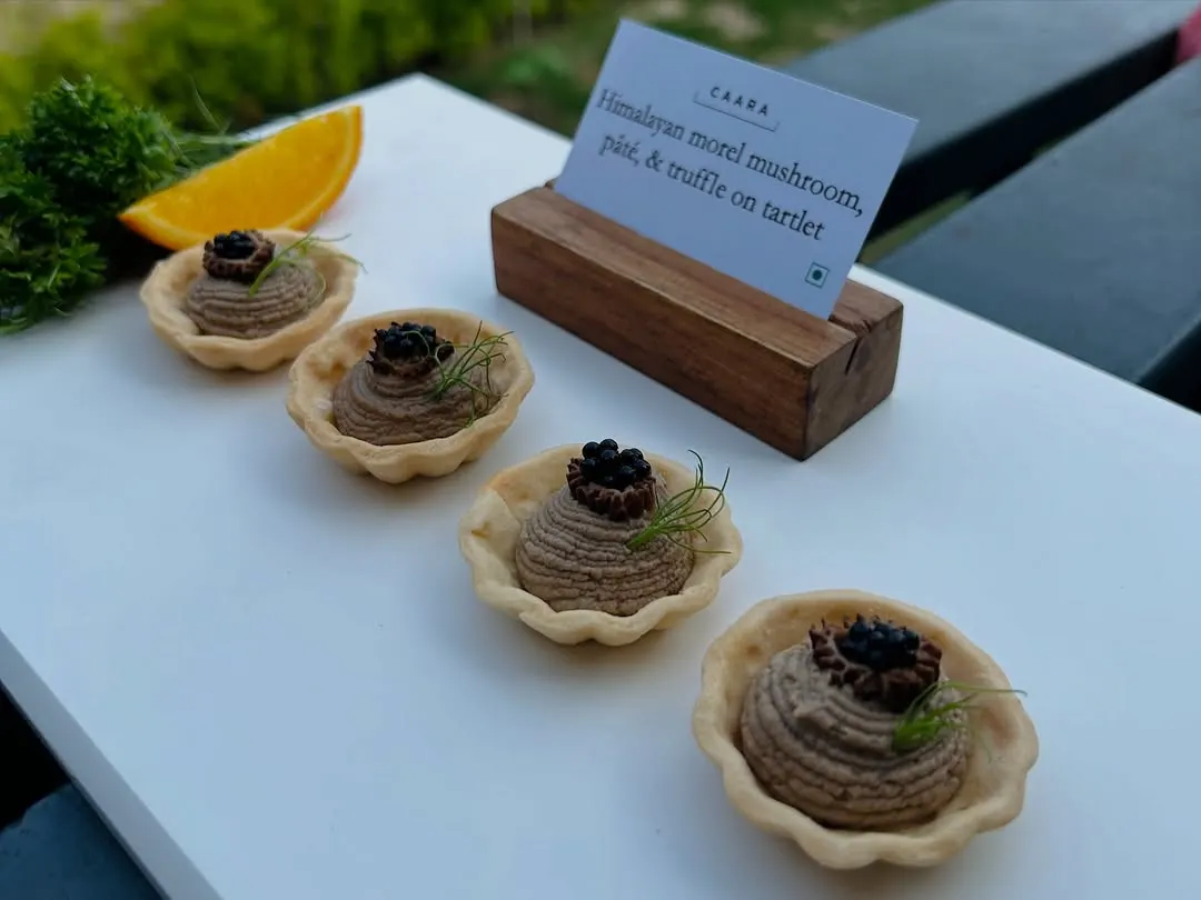 Our signature Himalayan morel mushroom, pâté, and truffle tartlets. This canapé highlights our commitment to using rare and exceptional regional ingredients, presented with an elegant touch for a truly gourmet bite.