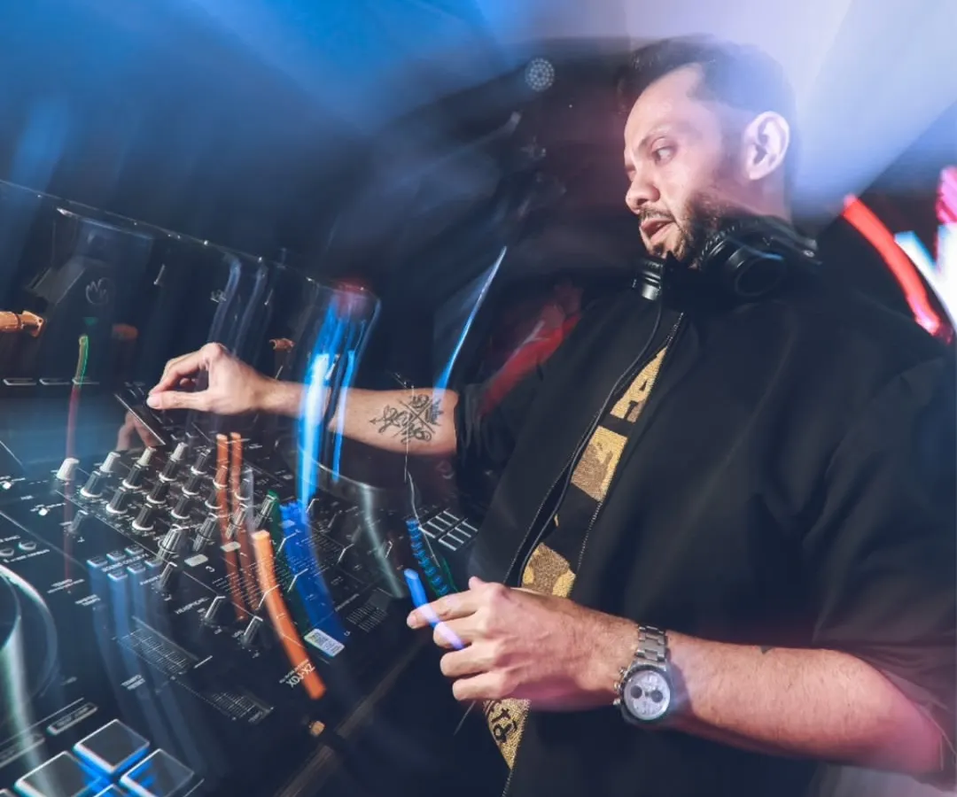 In the zone, mixing tracks and reading the room. This shot captures me doing what I love, blending beats to keep the party going, whether it's a high-energy tech house set or a retro pop night.