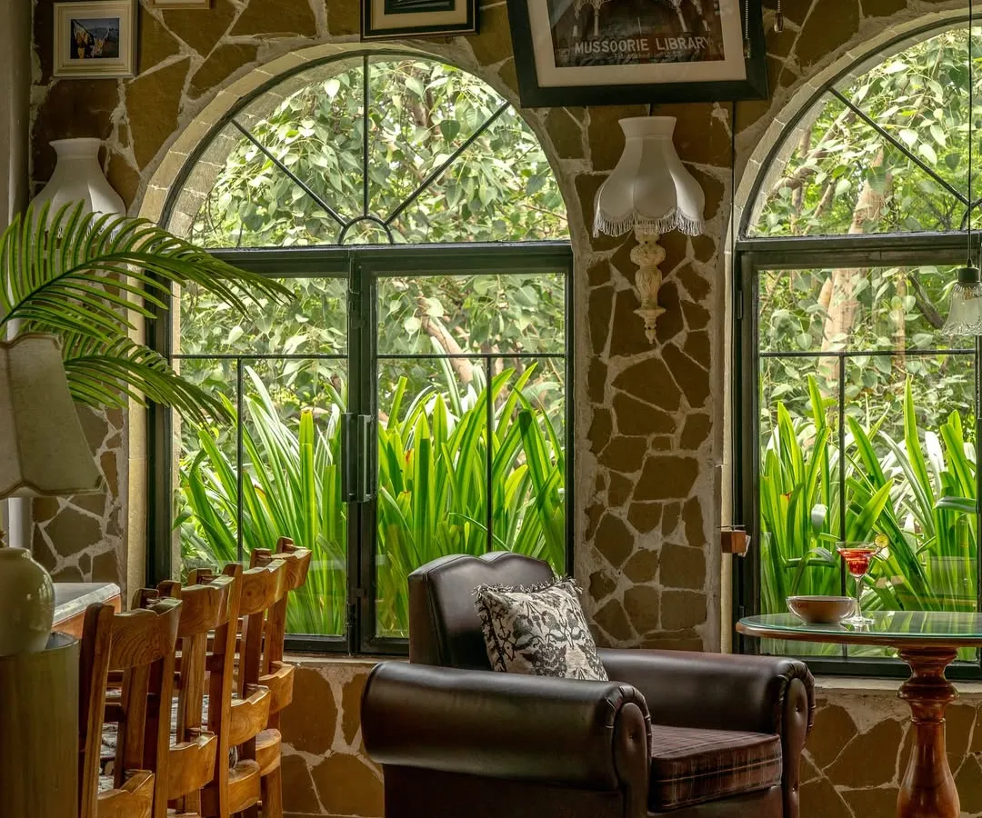 For Echoes Café, we transformed a challenging layout into a series of intimate, soulful corners. This nook, with its rubble-clad walls, arched window, and plush armchair, feels collected over time. It is a space designed not just for a meal, but for a moment of quiet reflection.