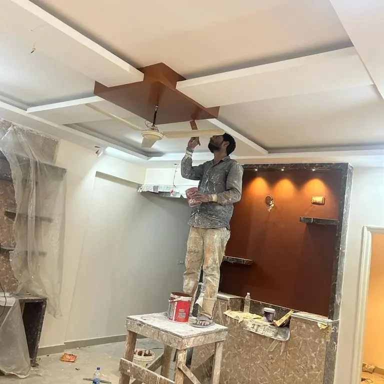 Our painter is giving the final touches to a complex false ceiling. We handle detailed work on multi-level ceilings, ensuring every edge and corner is painted to perfection for a sophisticated look.
