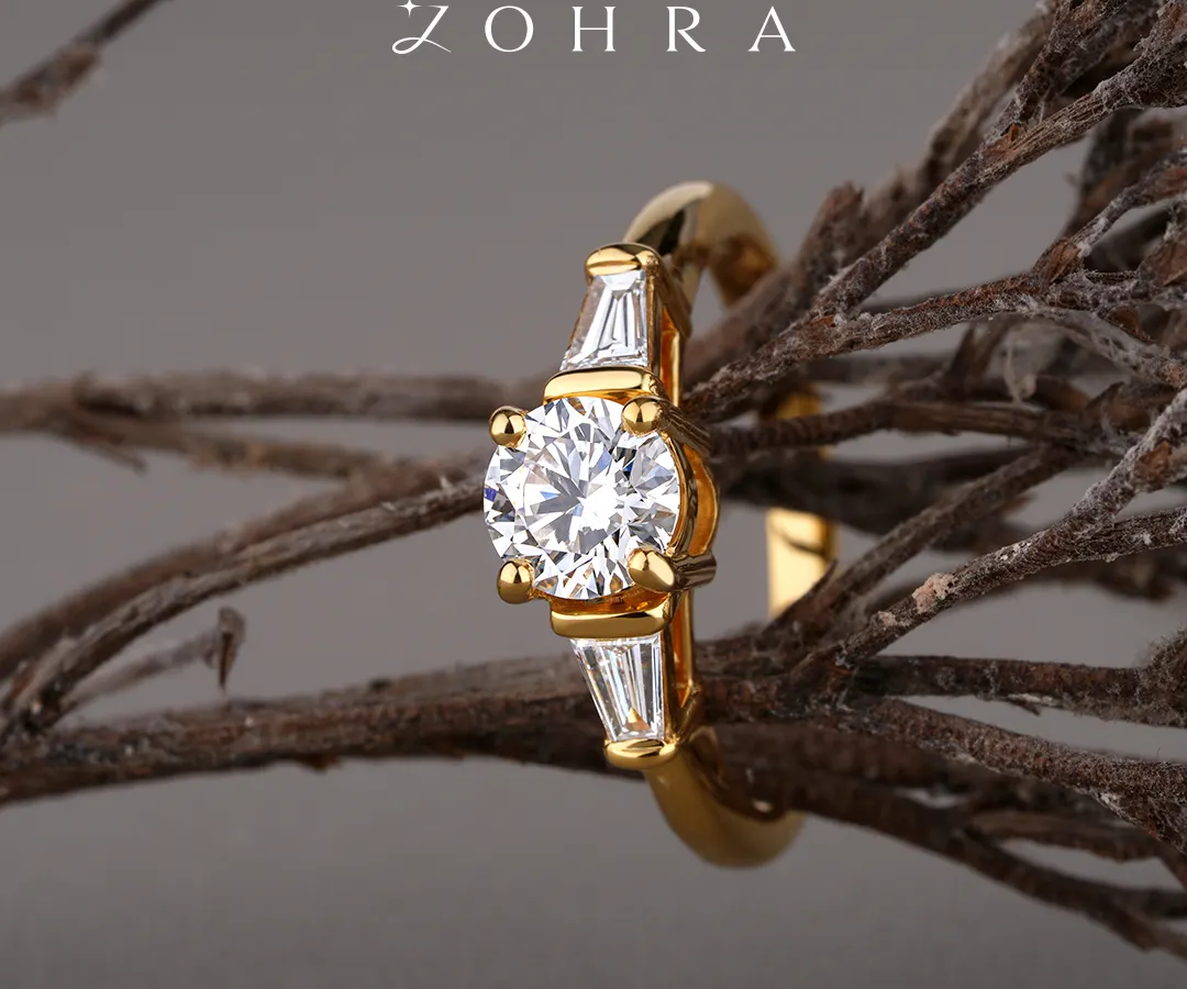A promise of forever should be as unique as your love story. This bespoke engagement ring features a brilliant-cut centre diamond, flanked by elegant baguette diamonds on a polished 18k gold band. I work with each client to ensure every element, from the diamond's cut to the band's design, perfectly captures their vision.