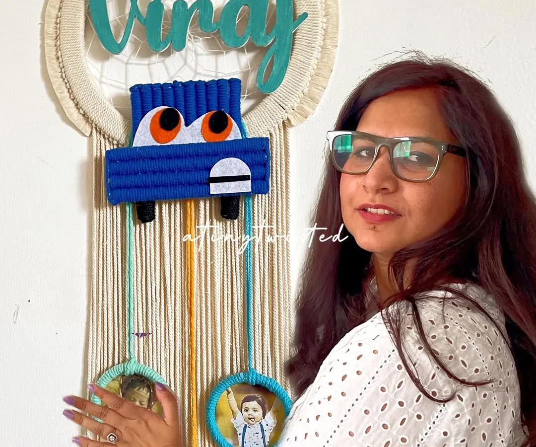 I love bringing your unique ideas to life, like this custom car-themed dreamcatcher nameplate. It features a hand-knotted car and three small frames below to hold precious photos, making it a truly personal piece of art for a child's room.