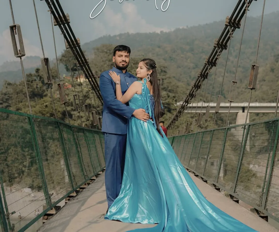 A fairytale moment on one of Rishikesh's iconic suspension bridges. The bride's flowing aquamarine gown contrasts beautifully with the rugged mountains, creating a truly breathtaking portrait that feels both grand and intimate.