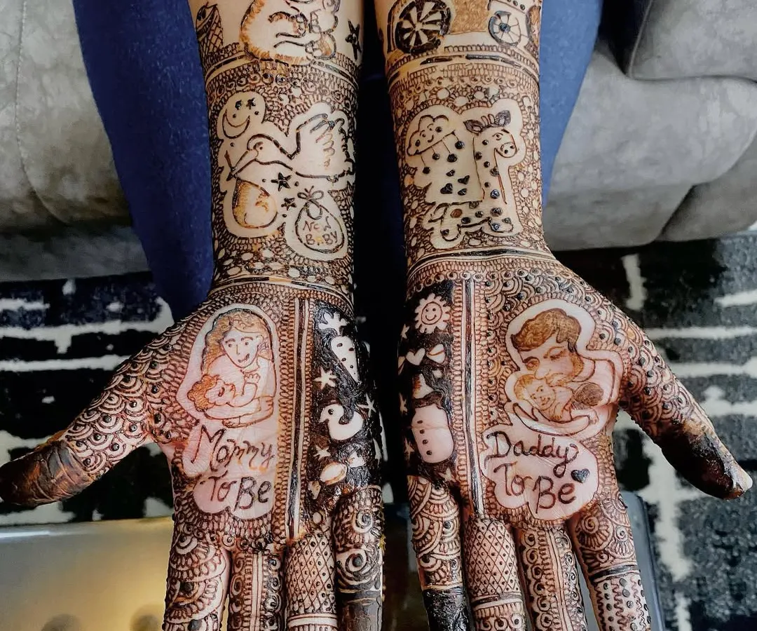 Celebrating the journey to motherhood with personalized baby shower mehndi. This design includes sweet portraits of the parents-to-be, along with adorable baby-themed elements like a toy train and a stork.